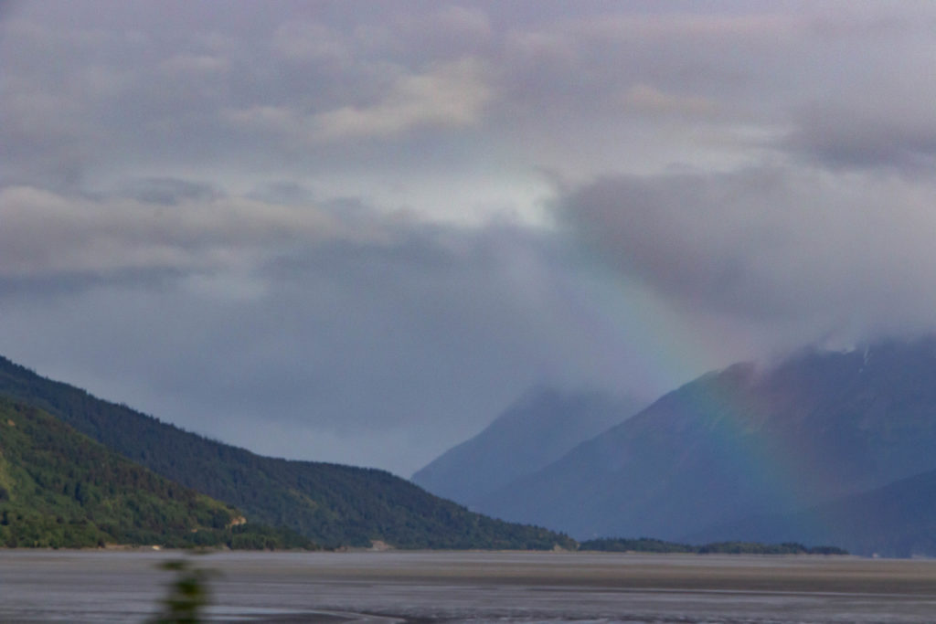 rainbow and mountains on cloudy day over turnigan arm waterway on seward highway alaska
