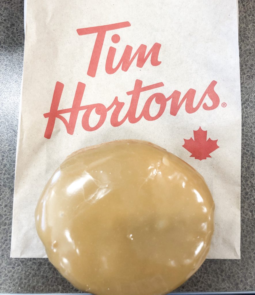 tim hortons maple creme filled donut on paper bag