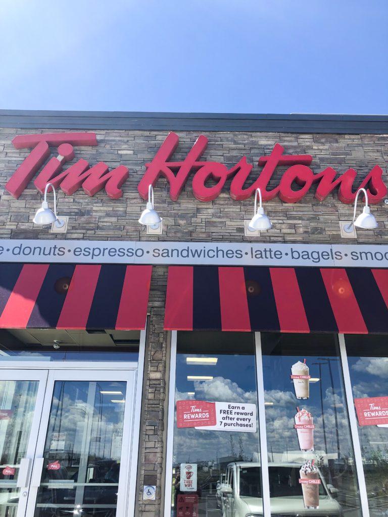 Tim Hortons coffee and donuts restaurant in alberta canada with blue sky